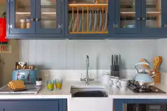 Shepherd's hut kitchen with a sink, hob, fridge, freezer and dishwasher