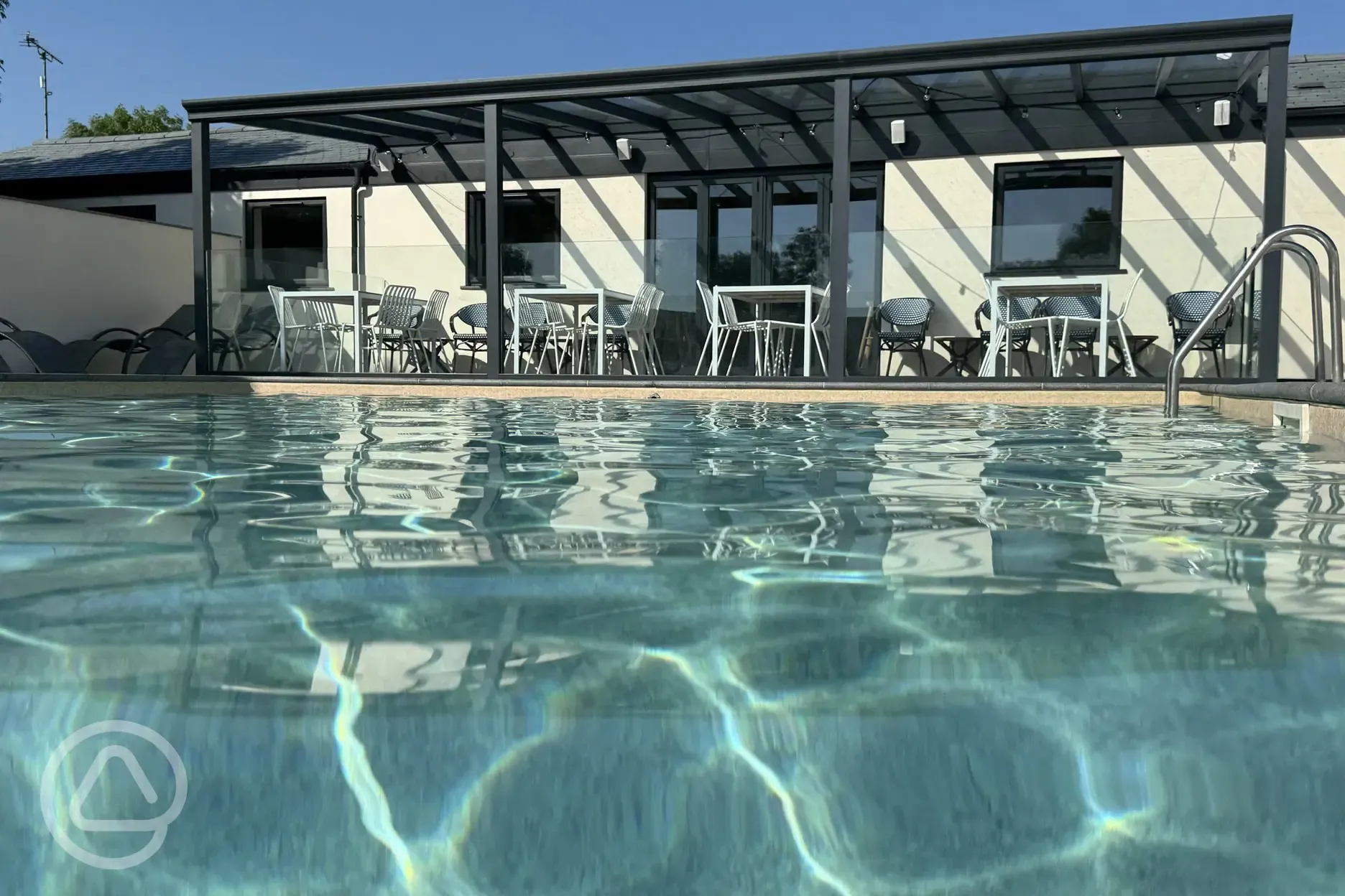 Outside heated swimming pool and seating by Surfrider bar