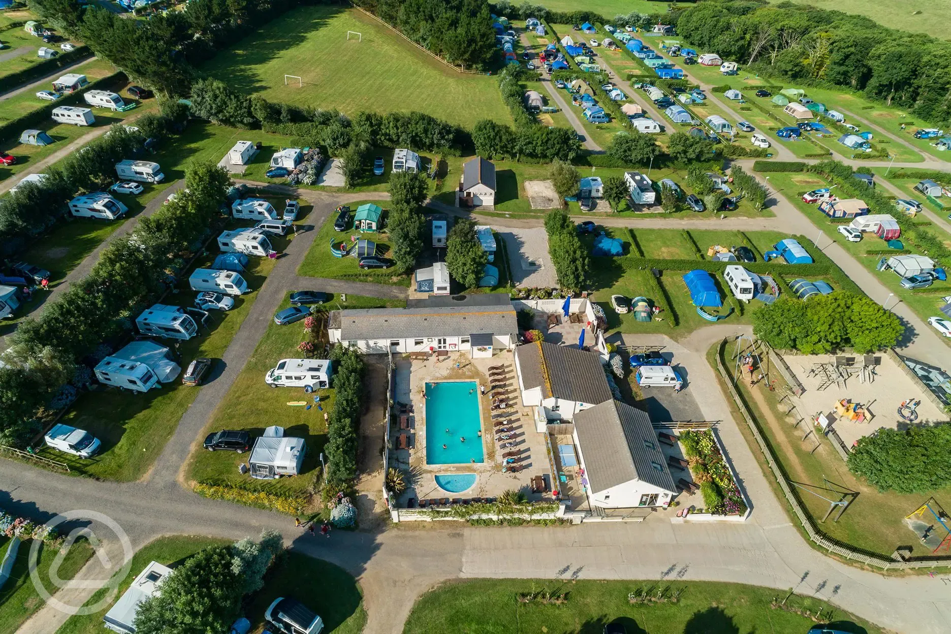 Bird's eye view of Treloy Touring Park with the outdoor swimming pool