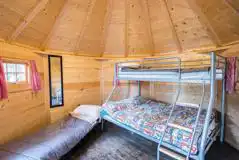 Camping cabin bunk bed and fold-out camp bed (bedding not provided) Camping cabin bunk bed and fold-out camp bed (bedding not provided)