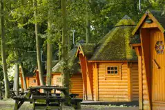 Camping cabins exterior with picnic benches Camping cabins exterior with picnic benches