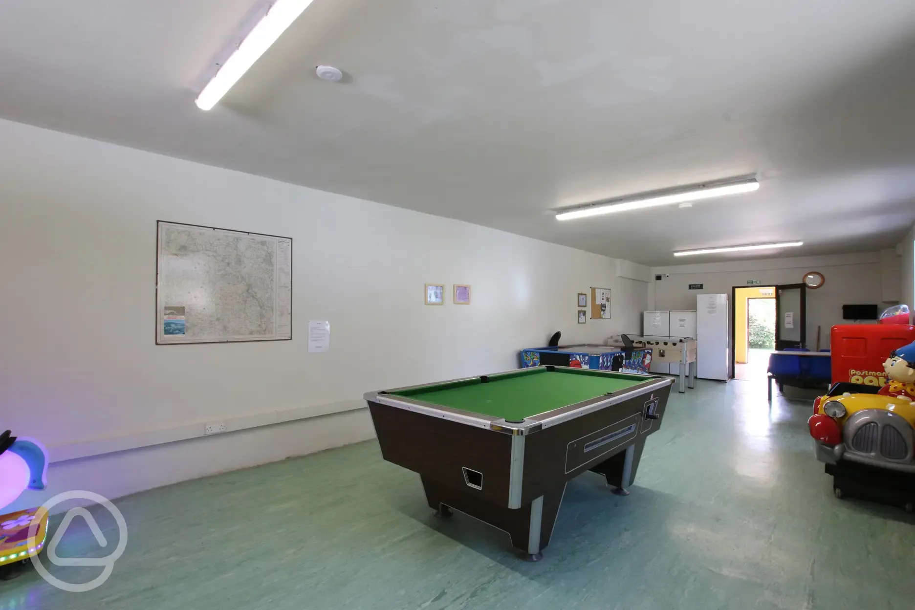 Games room with a pool table, a TV and arcade games