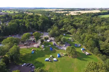 Aerial of Golden Valley Caravan Park, surrounded by historic woodland