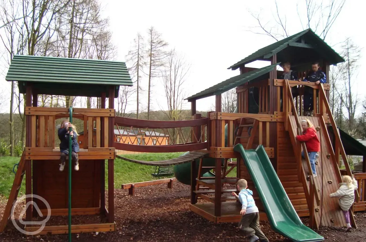 Children's play park with climbing area and a slide