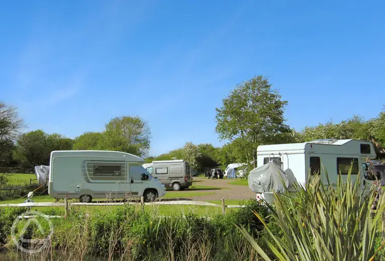 Hardstanding pitches beside a lake at Appuldurcombe Gardens