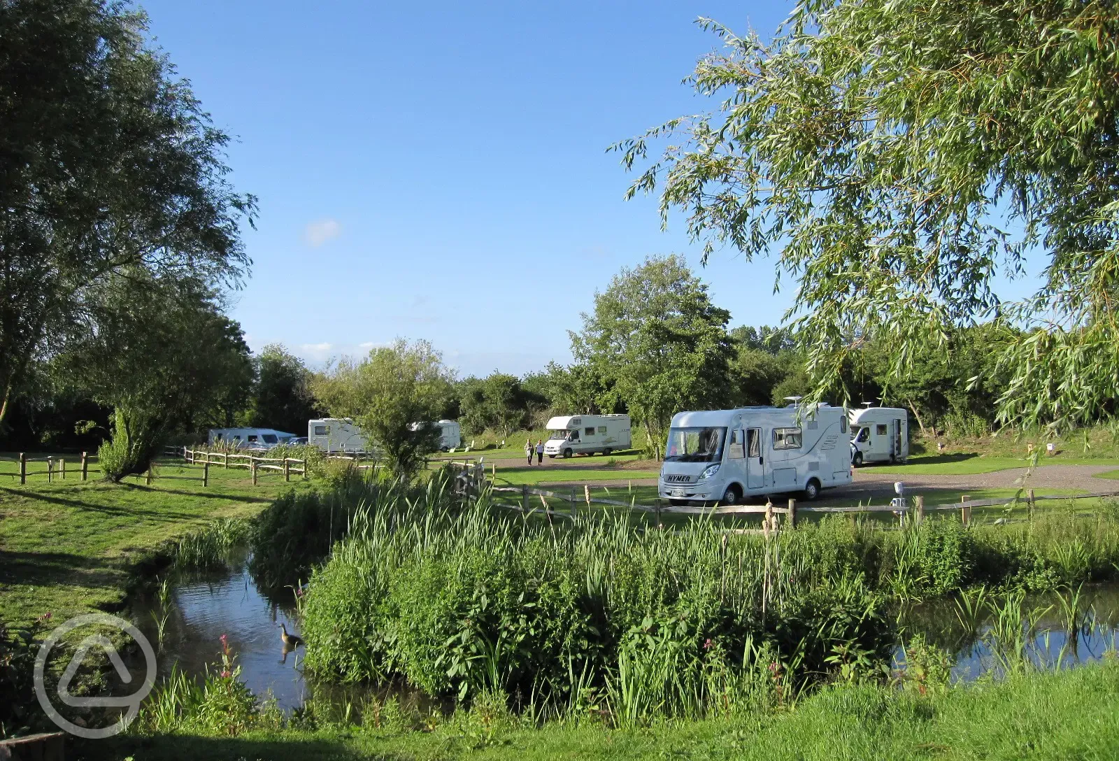 Hardstanding pitches beside a lake Hardstanding pitches beside a lake