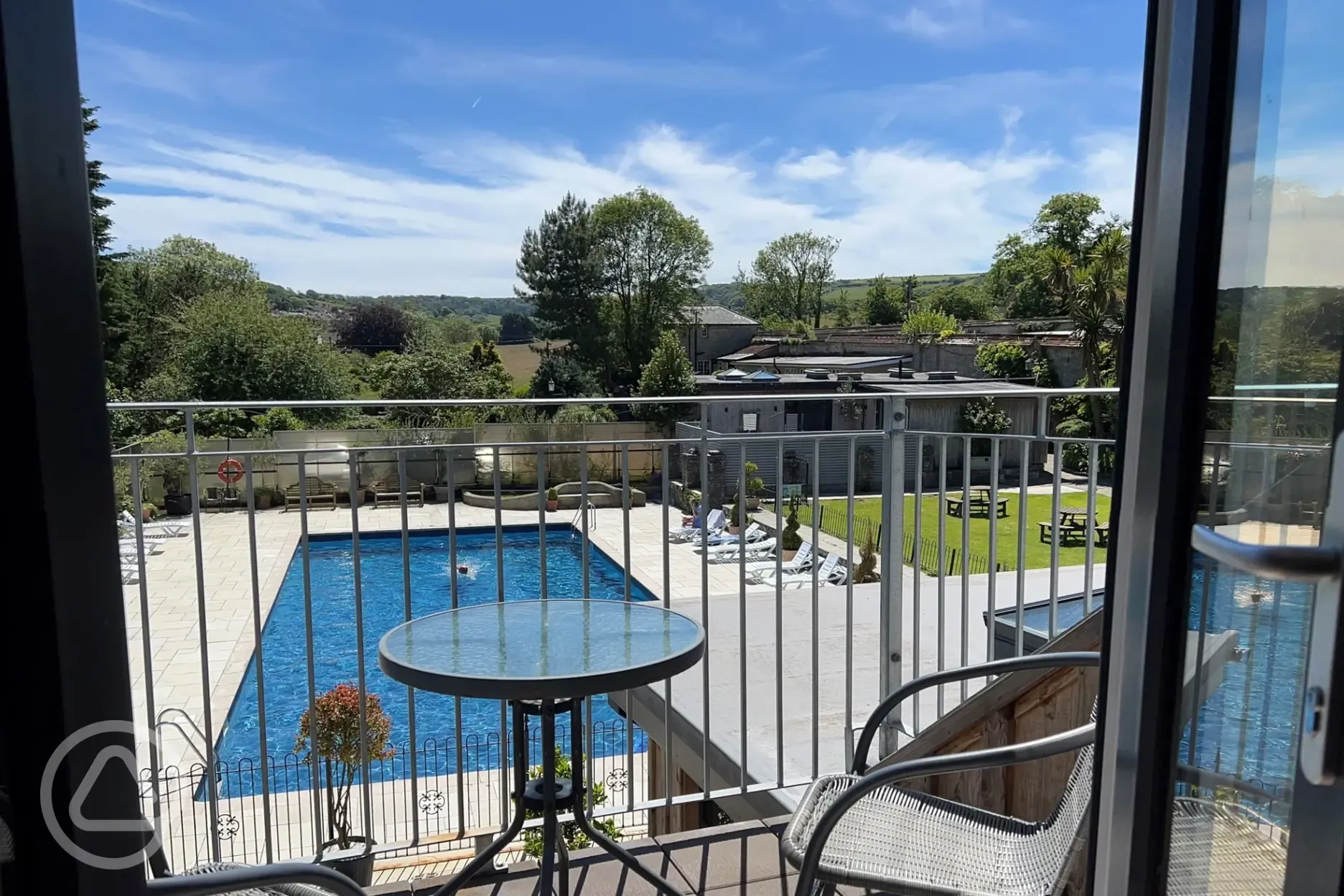 Cafe seating overlooking the outdoor heated swimming pool Cafe seating overlooking the outdoor heated swimming pool
