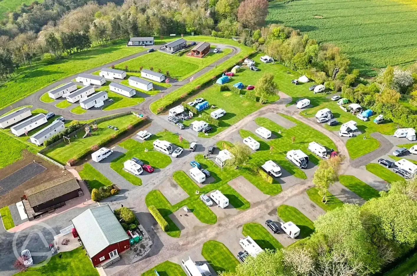 Aerial view of hardstanding and grass pitches with static caravans