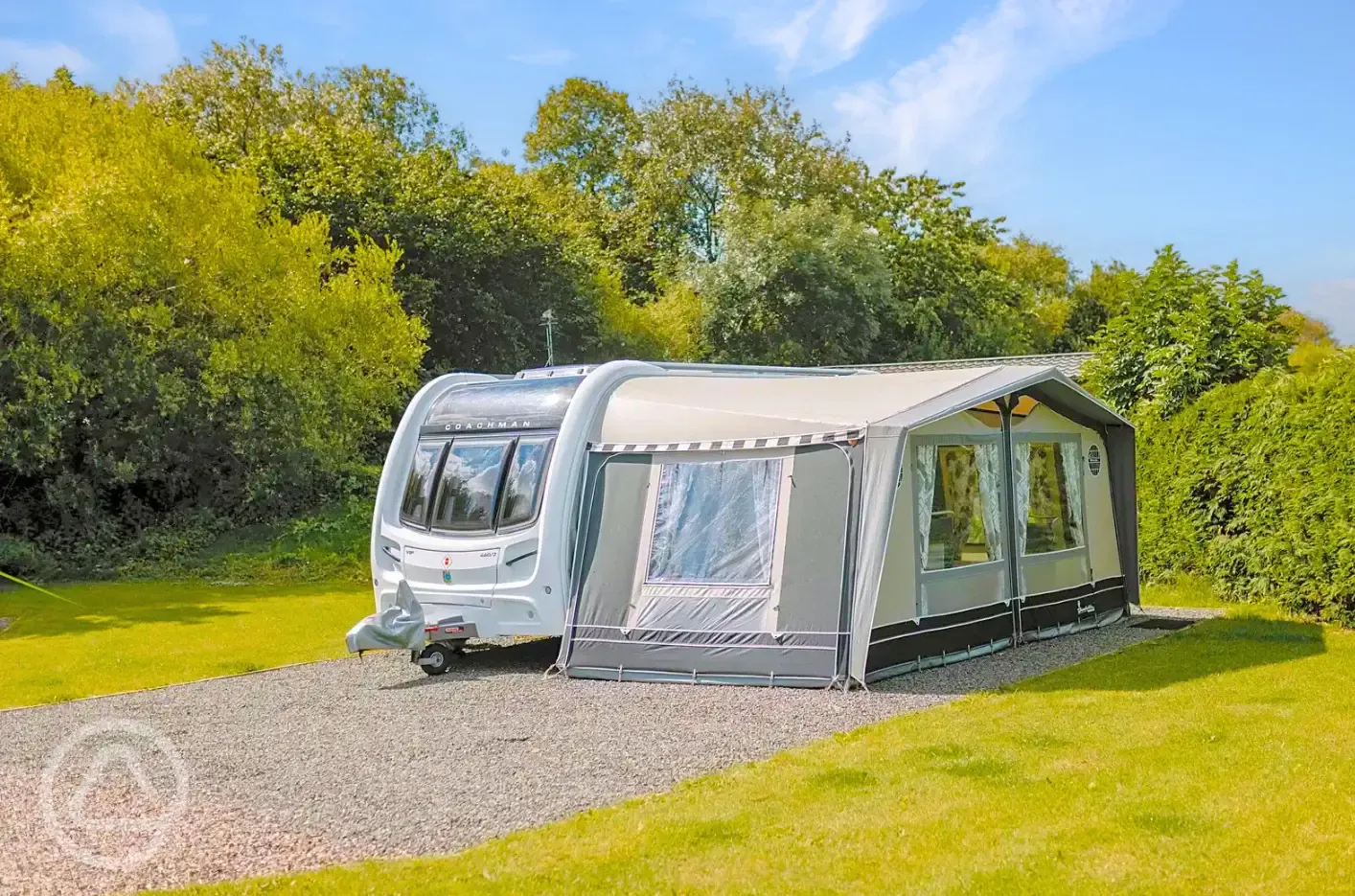 Fully serviced hardstanding pitches with a caravan with awning