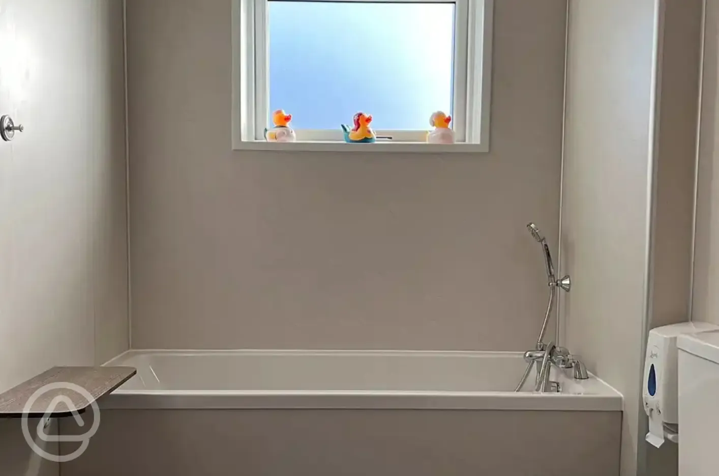 Family bathroom with bath tub, shower, baby changing area and hair dryers