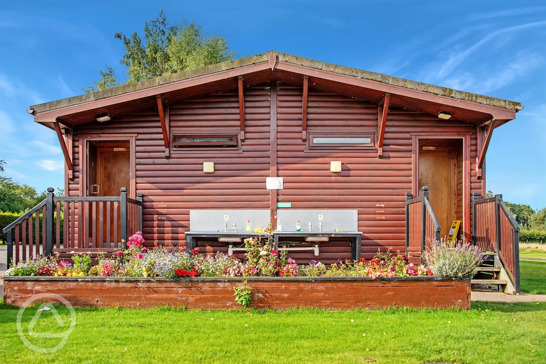 Facility block, reception and shop with hardstanding pitches