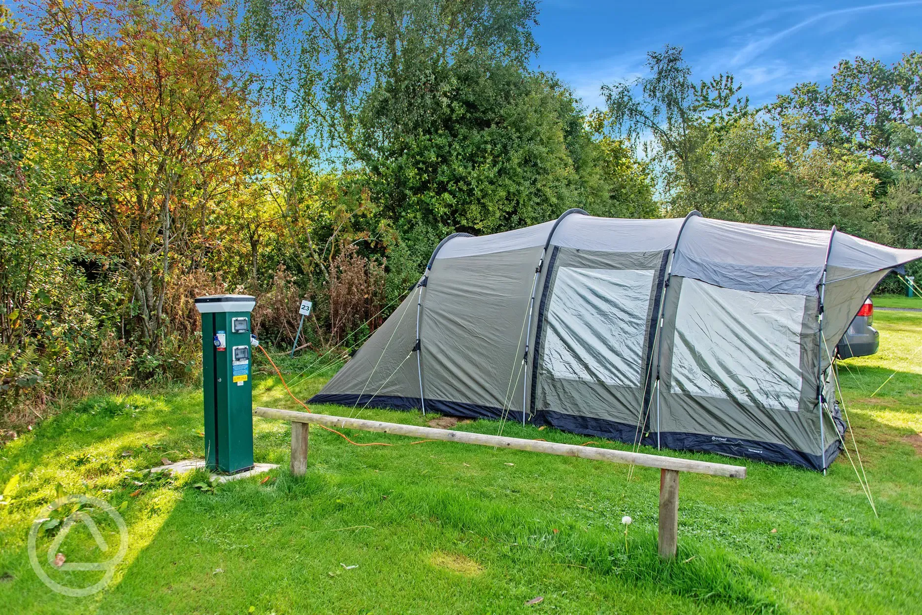 Large electric grass pitches with a tent