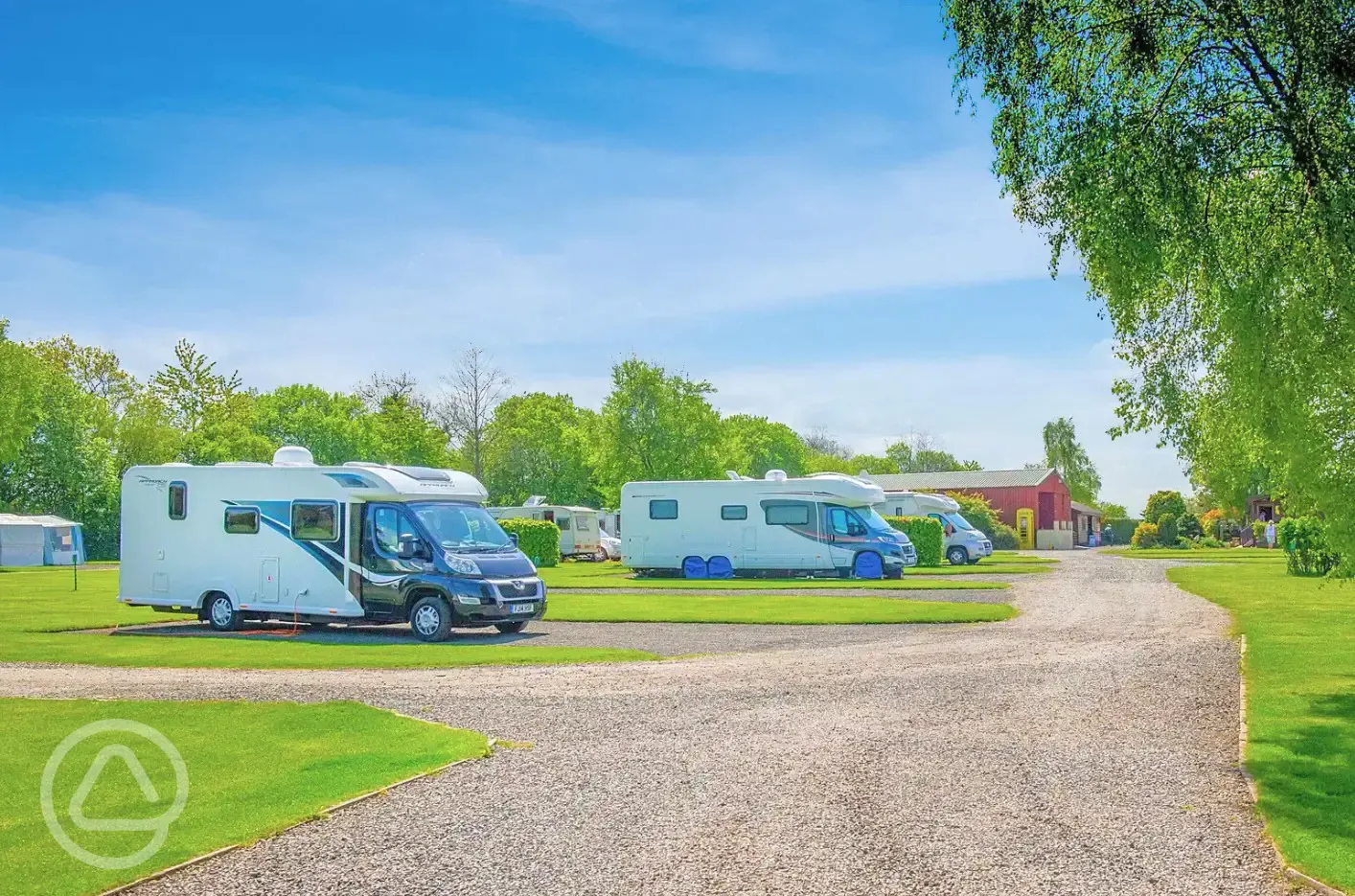 Fully serviced hardstanding pitches with the facility block behind
