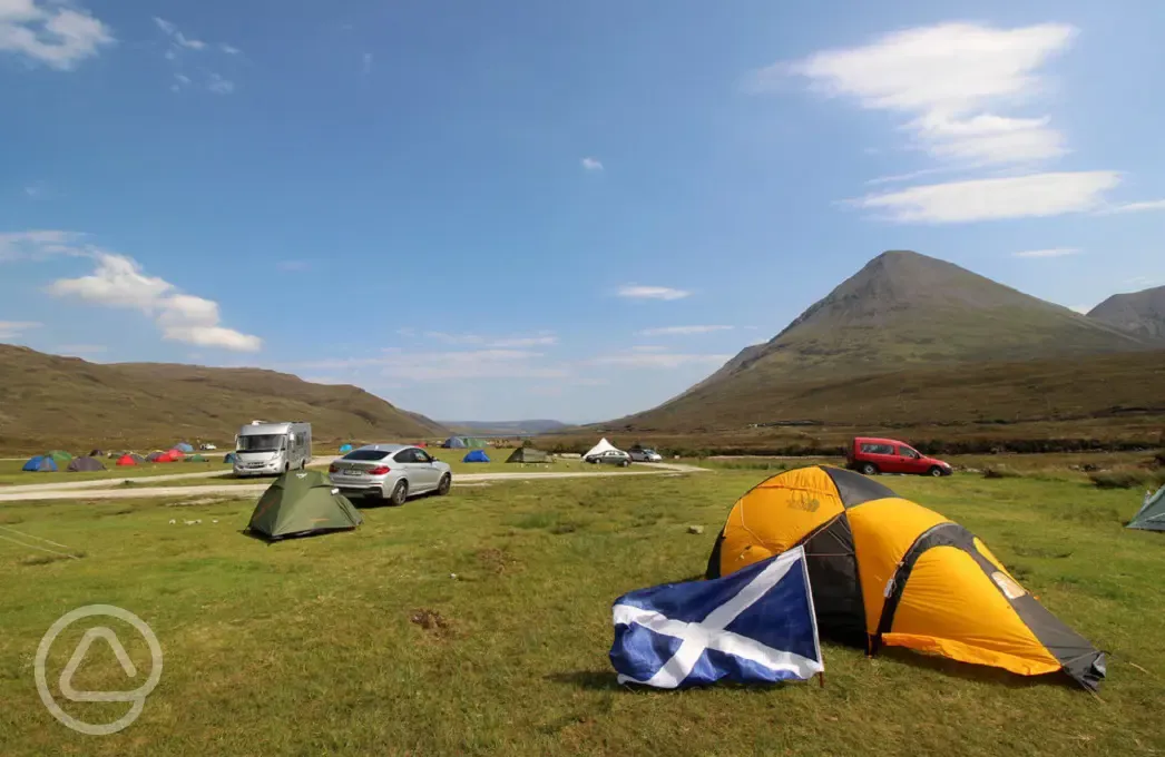 Tents spread between the mountains at Sligachan Campsite