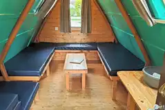 Camping pod interior with four sleeping platforms (please bring bedding) Camping pod interior with four sleeping platforms (please bring bedding)
