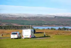 Electric hardstanding touring pitches with loch and mountain views