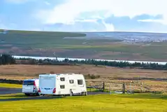Electric hardstanding pitches with views to Loch Shin