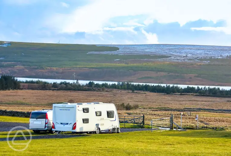 Electric hardstanding pitches with views to Loch Shin