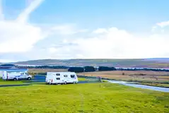 Electric hardstanding touring pitches with loch and mountain views