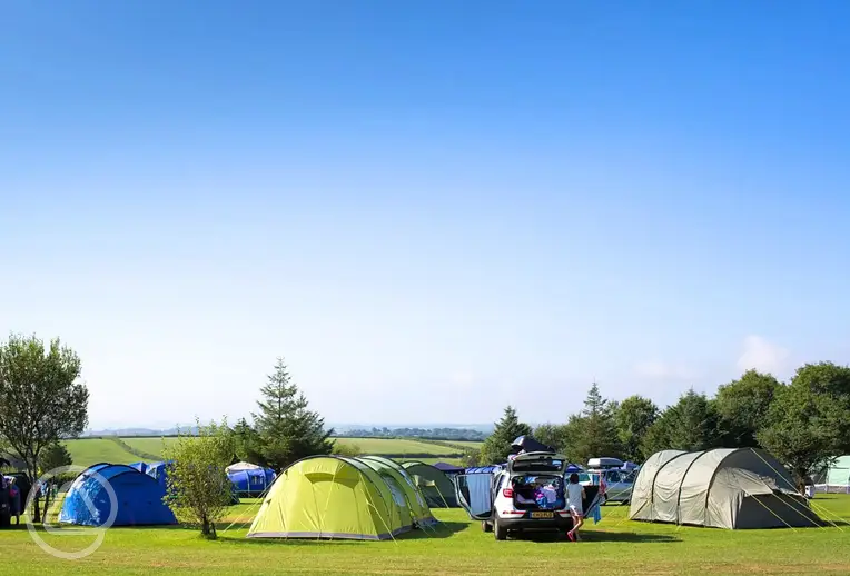 Grass pitches at Little Kings Holiday Park with countryside and sea views