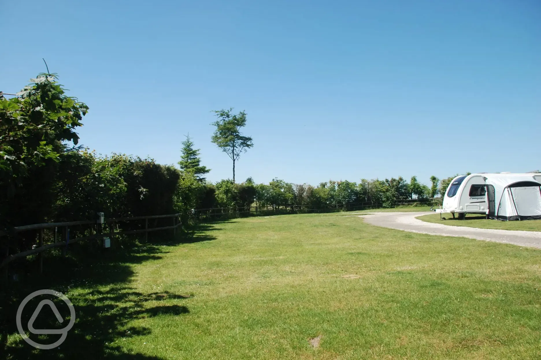 Electric grass pitches measuring 6m by 8m and suitable for tents and tourers