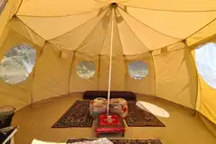 Foxglove bell tent with rugs and futons