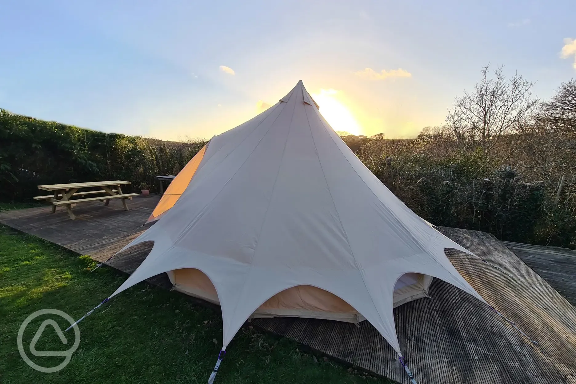 16m Primrose bell tent with private decking at sunset