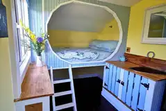 Bluebell interior with a double bed and furniture Bluebell interior with a double bed and furniture