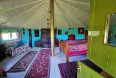 The roundhouse interior with a king size bed and two fold away camp beds