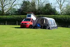 Large grass pitch for units up to 8m x 6m with optional electric