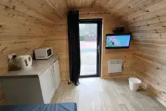 Ensuite pod interior with a Freestat TV and kitchen area