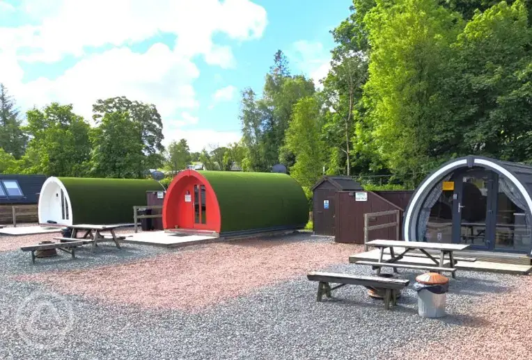Deluxe glamping pods with hot tubs and privacy fencing