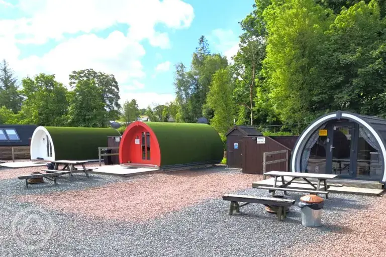 Deluxe glamping pods with hot tubs and privacy fencing