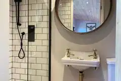 Hare's Retreat glamping cabin ensuite shower with a mirror