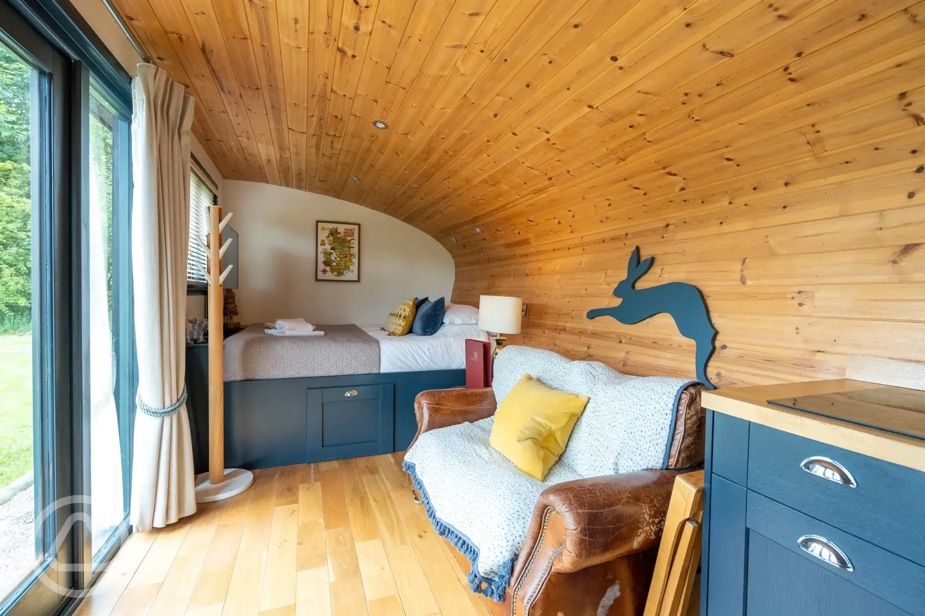 Robin's Nest glamping cabin bed and living area