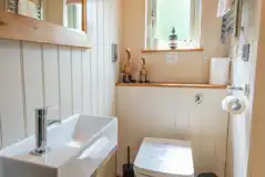 Bertie's Retreat ensuite with a toilet, toilet rolls, and handwashing sink