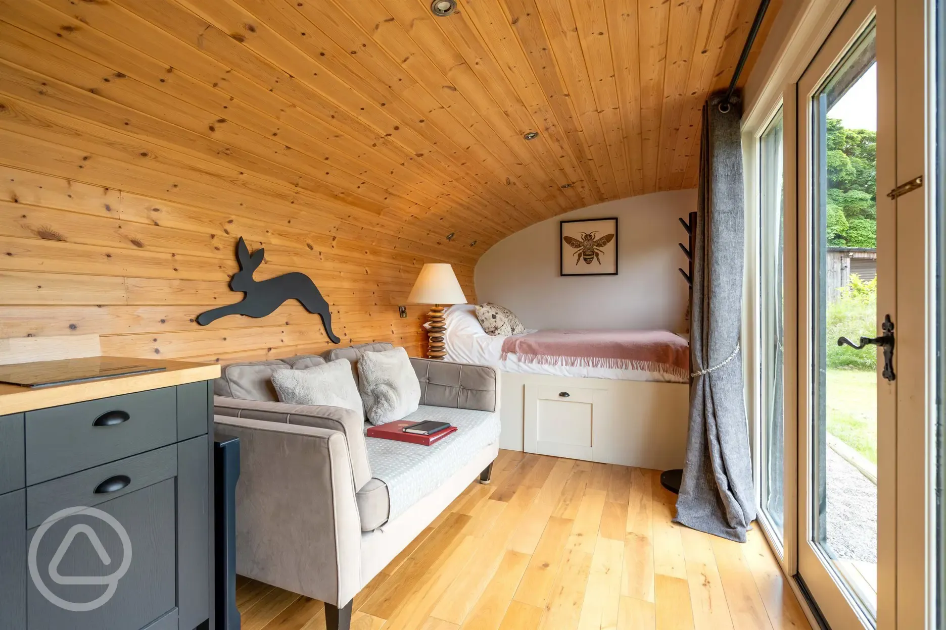 Meadow View glamping cabin bed and living area