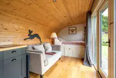 Meadow View glamping cabin bed and living area