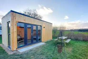Bluebell camping pods with a picnic bench and fire pit