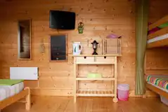 Camping cabin with a king size bed, TV, fridge, kettle and microwave