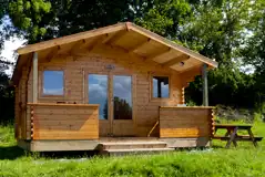Camping cabins with an outdoor picnic table