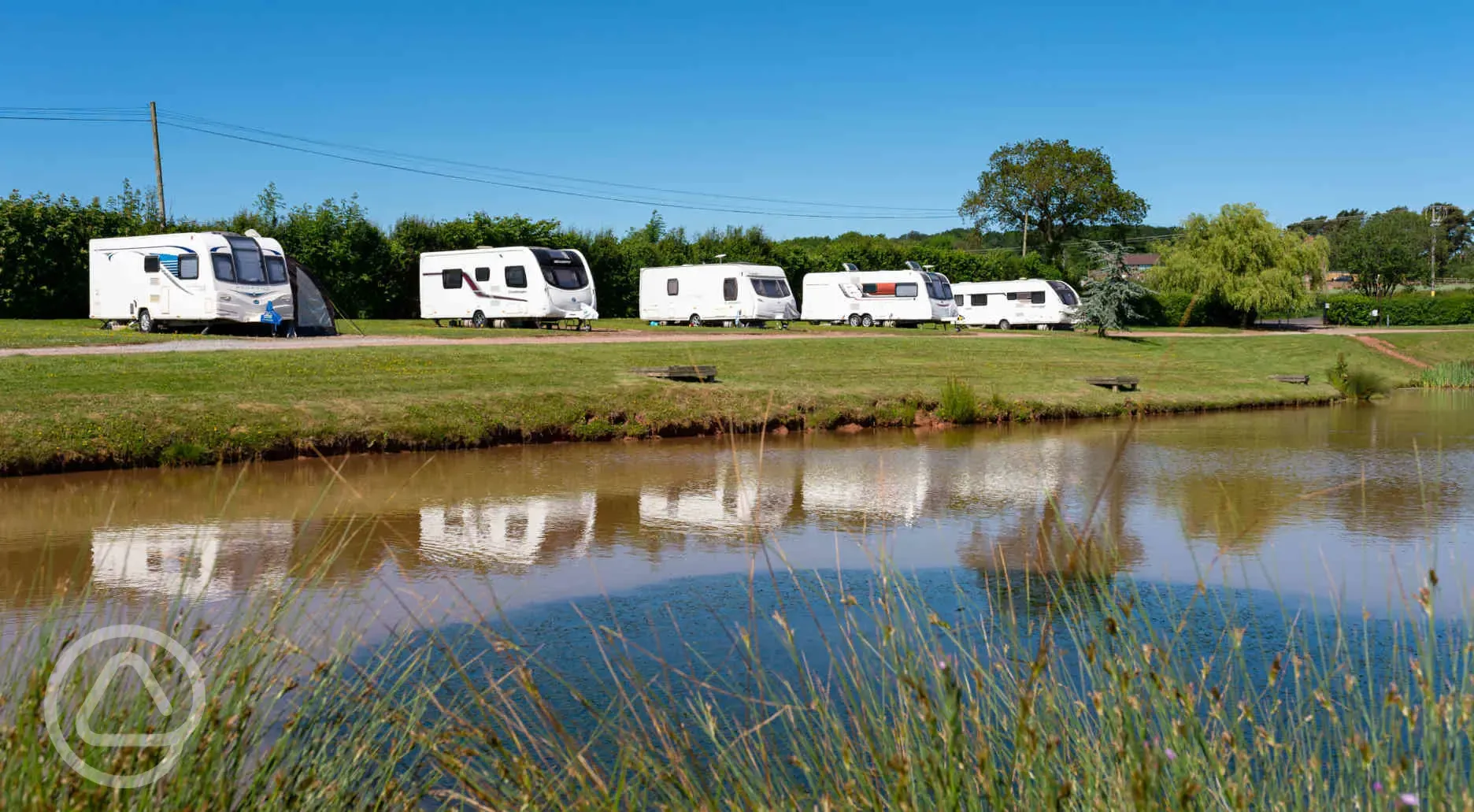 Fully serviced hardstanding touring pitches by the lake