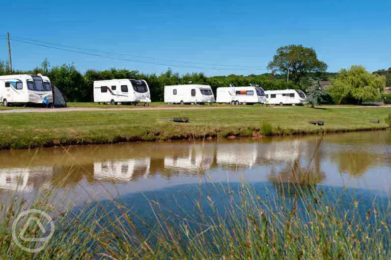 Fully serviced hardstanding touring pitches by the lake