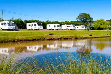 Fully serviced hardstanding touring pitches by the lake
