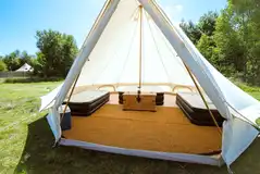 Bell tent interior with a double air mattress and two single mattresses