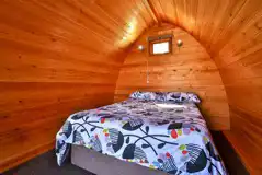 Double bed inside camping pod