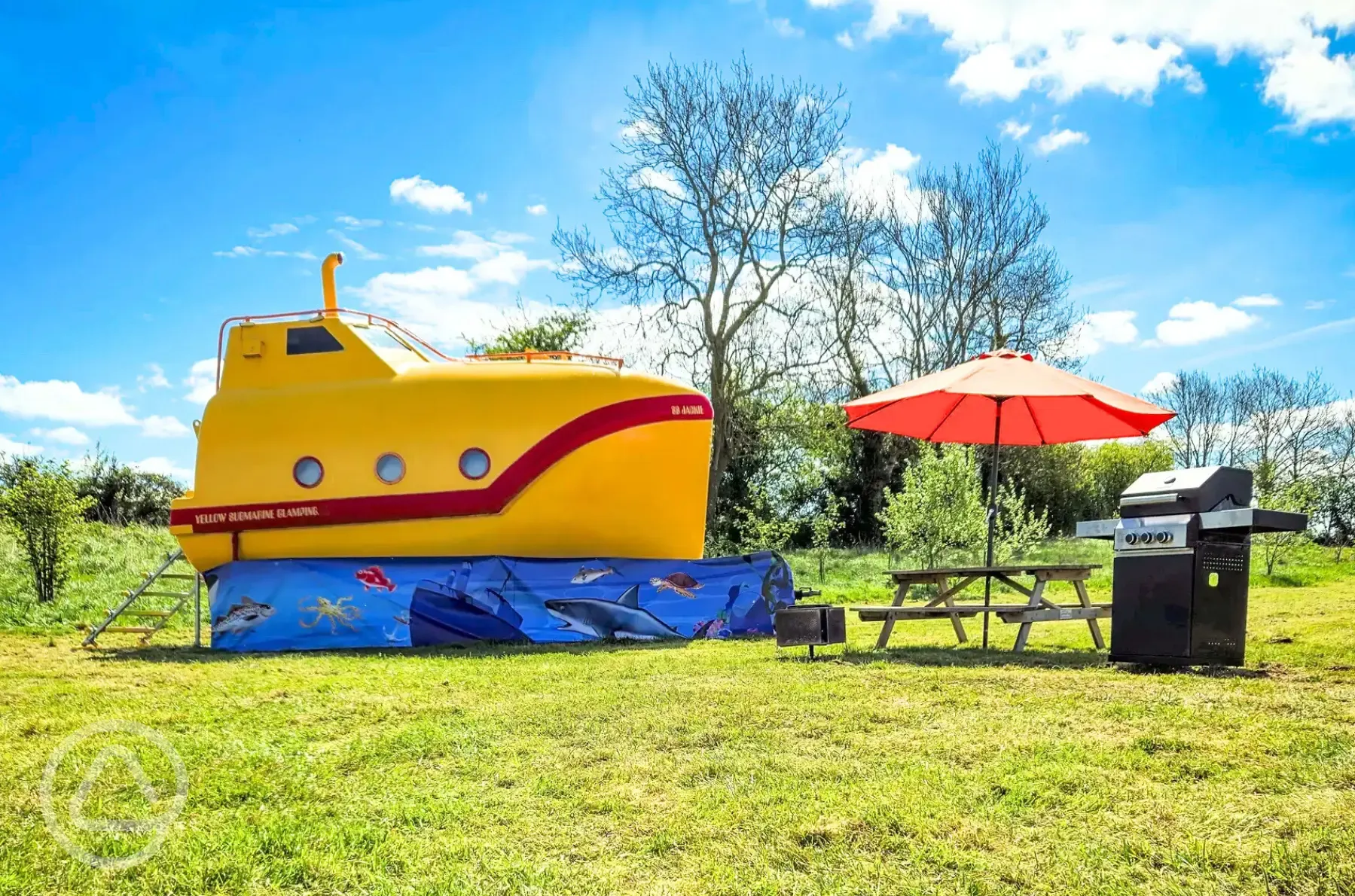 Unique yellow submarine with a BBQ, fire pit and bench