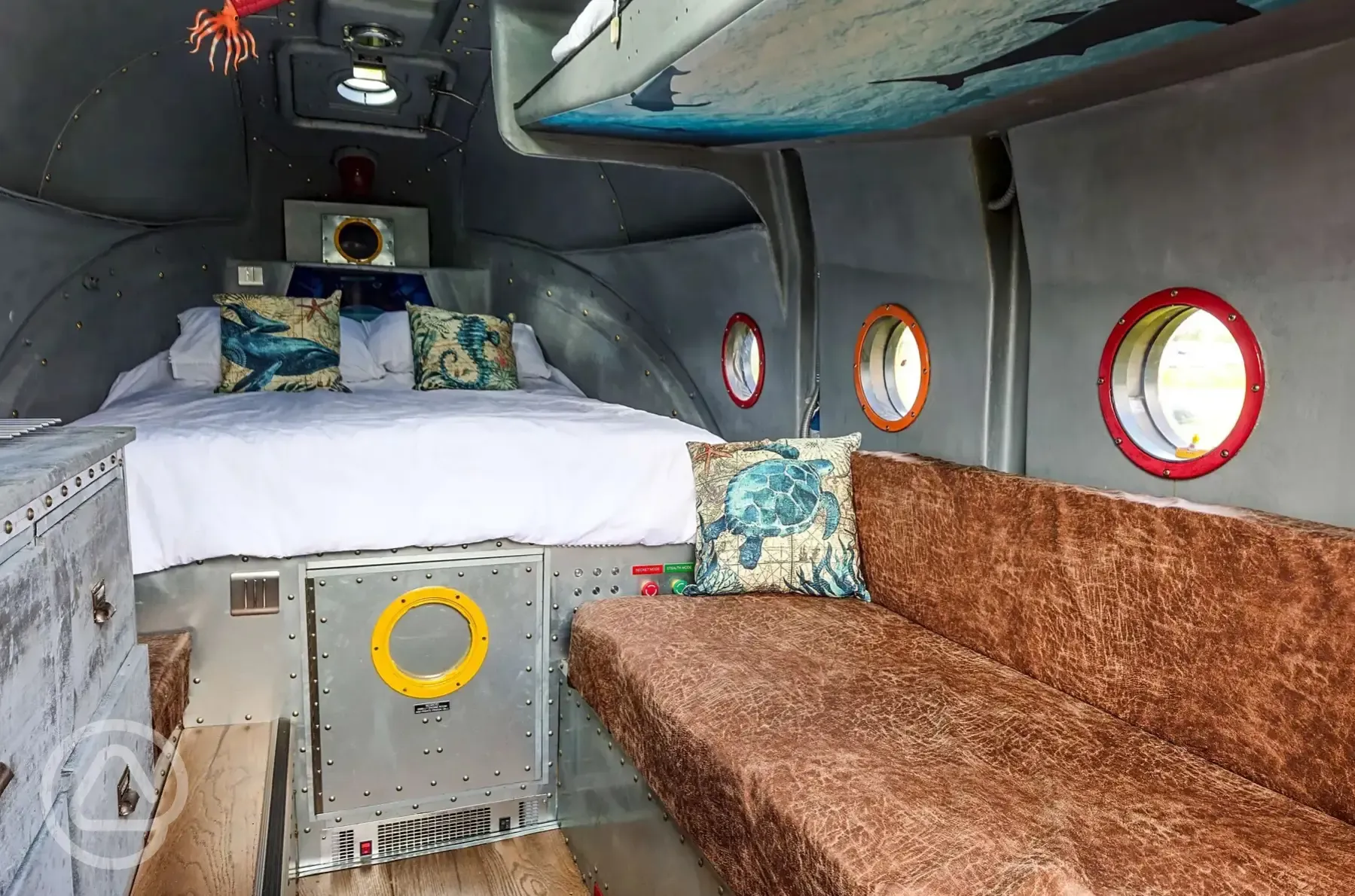 Unique yellow submarine interior double bed and single sofa area