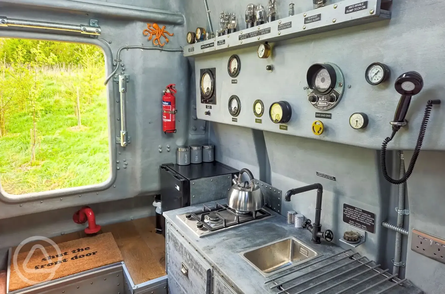 Unique yellow submarine kitchen with a hob, sink and fridge