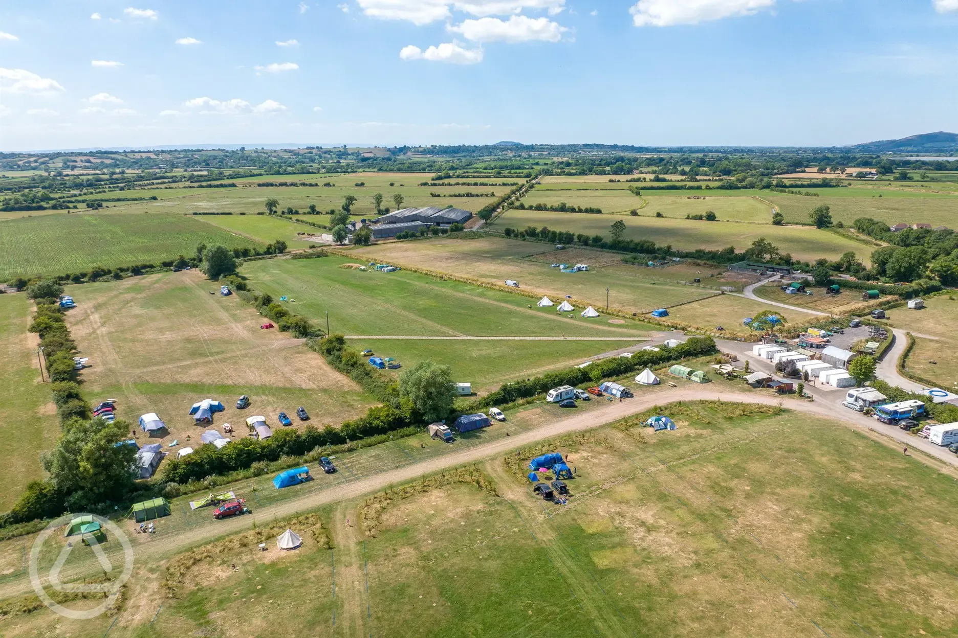 Campsite aerial with distant views of the Somerset countryside
